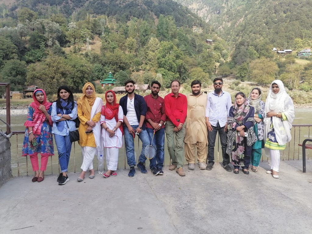 Geography faculty and students beside a mountain stream in Kuttan, AJK