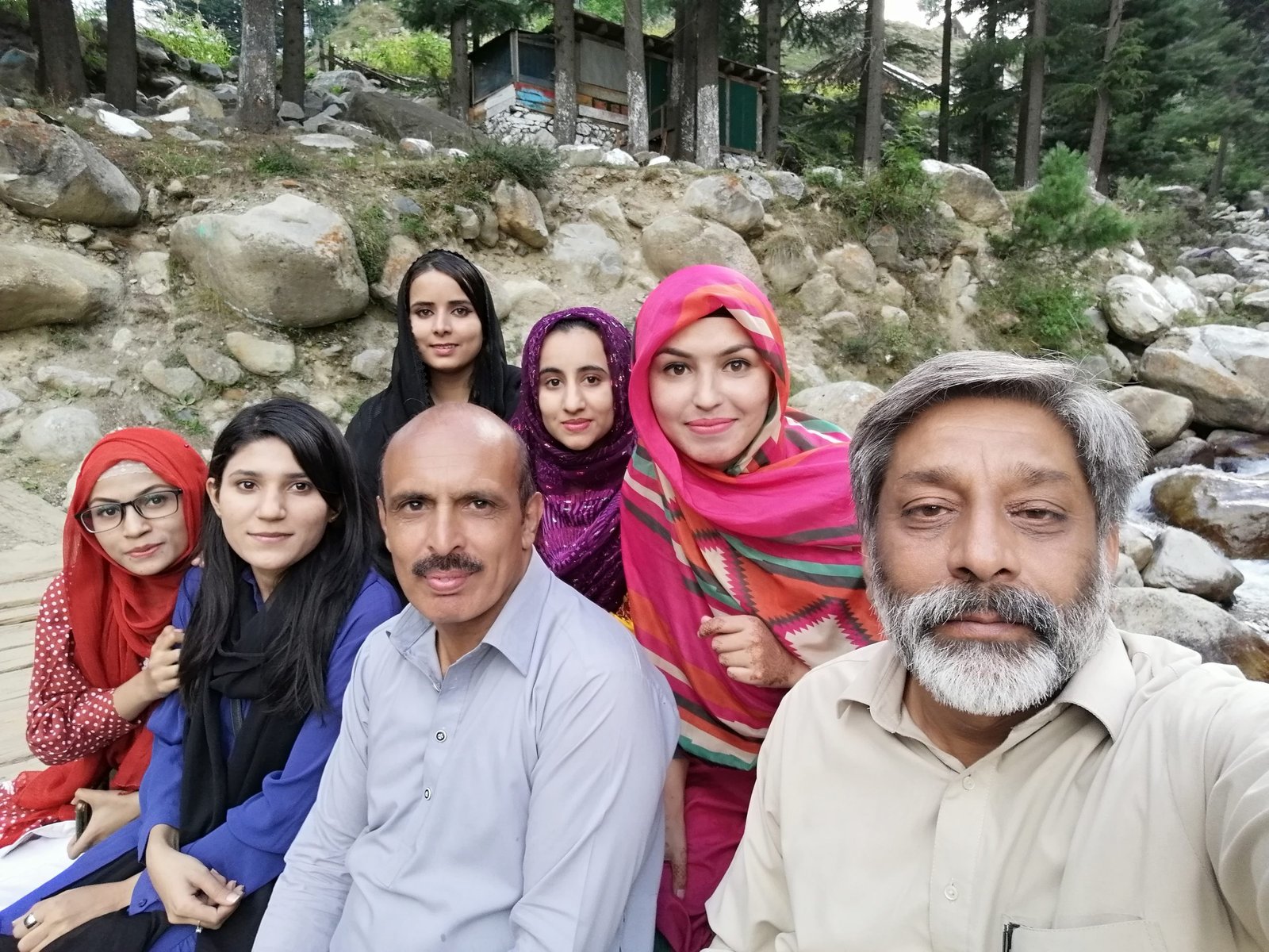 Faculty and students by a mountain stream during the Kuttan, AJK field visit