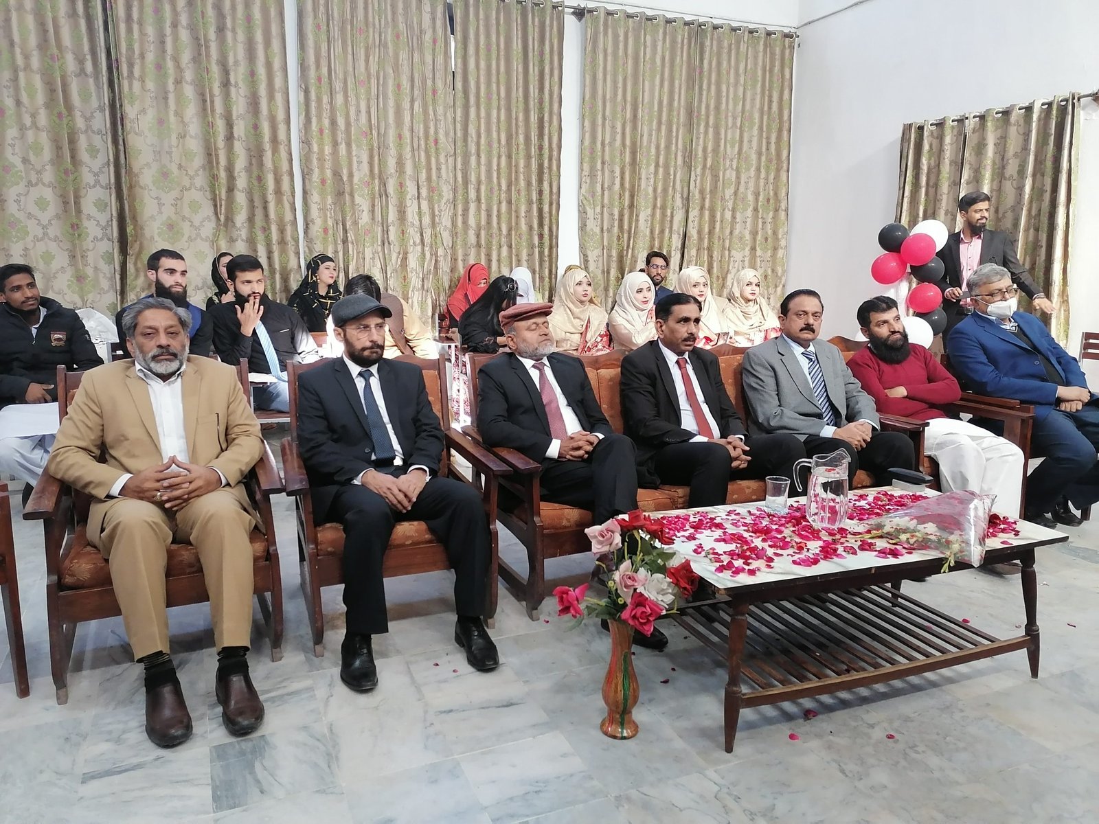 Faculty and students at a departmental farewell gathering