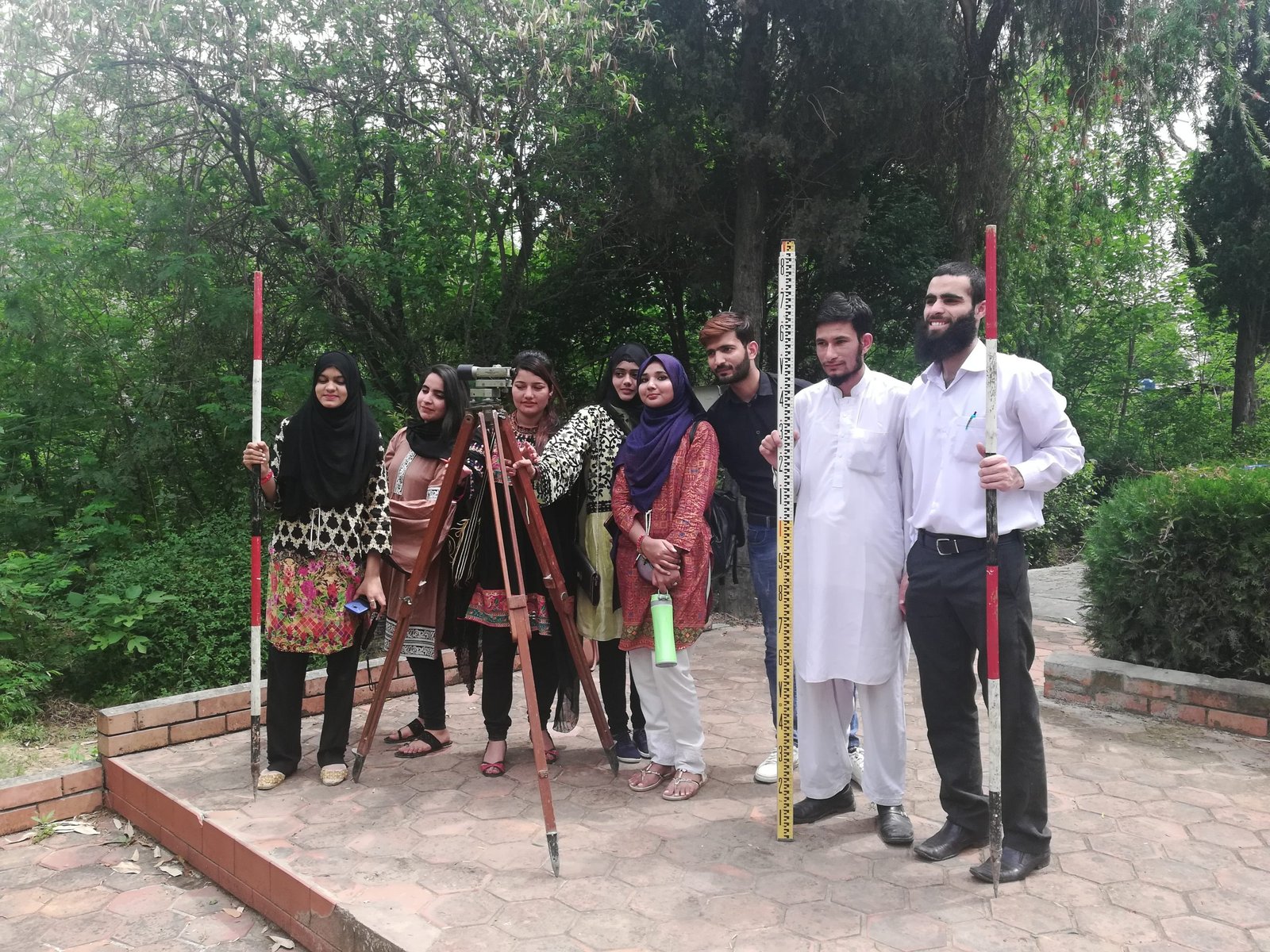 Geography students and faculty with surveying equipment after a field practical